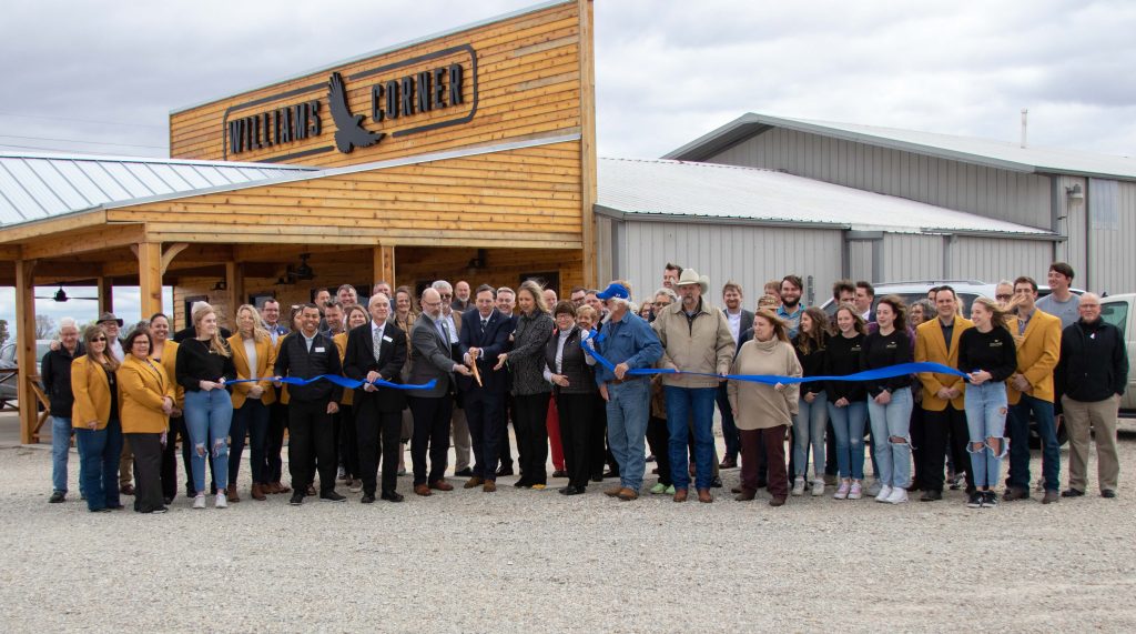 WBU Board members hold a blue ribbon that has just been cut in honor of Williams Corner Store opening.